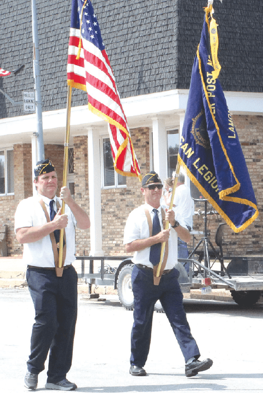 two american legion members walking in the parade